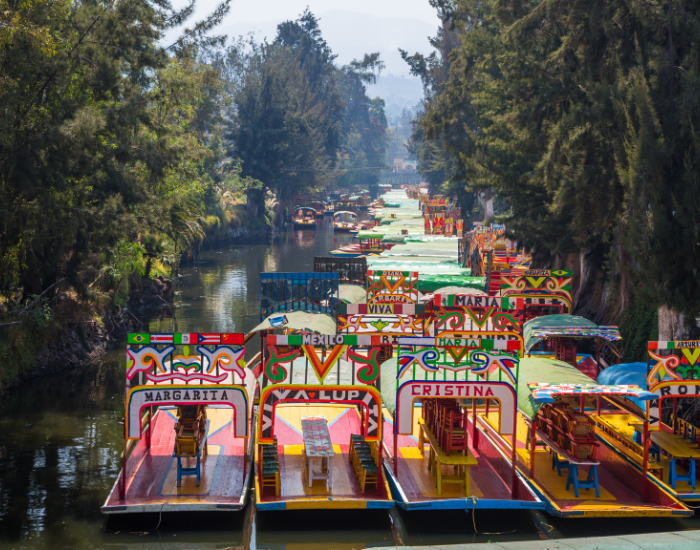 canals of xochimilco with many traditional boats parked