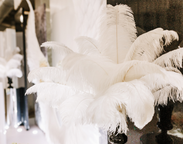 White ostrich feather wedding decoration on table