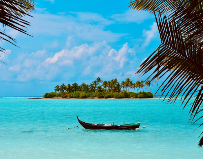 Lakshadweep-Islands.webp Lakshadweep Islands panoramic view of an island with crystal blue water and a small boat in front