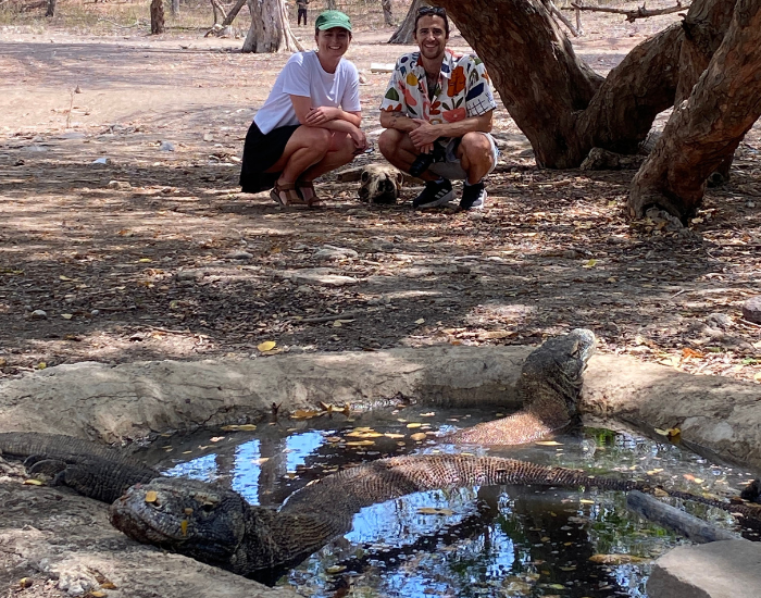 liveboard-komodo-national-park-3.webp two people with a komodo dragon in the wild