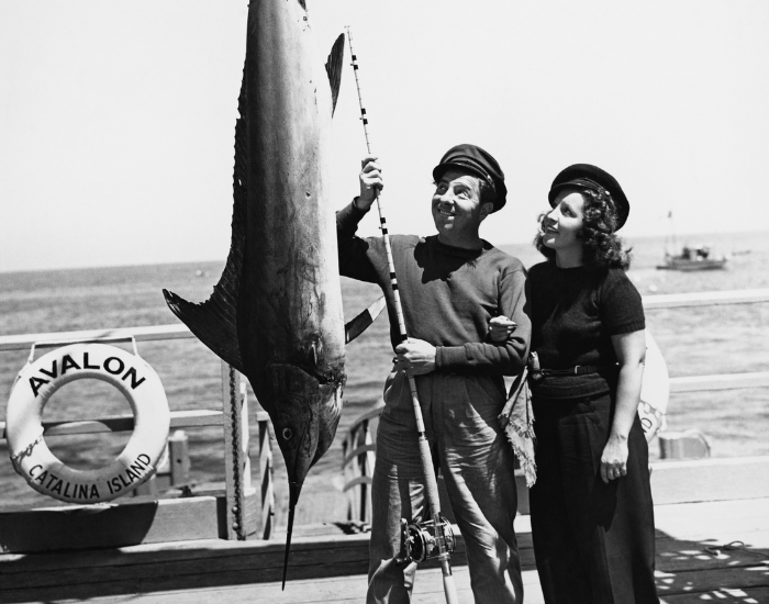Anglers posing with a large female blue marlin caught off the Pacific coast, circa 1950s