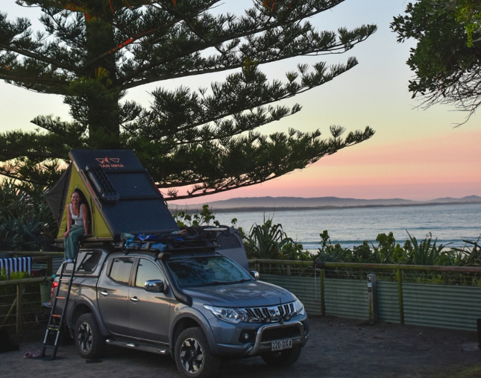 Vehicle with setup roof tent parked overlooking the coast near Lake Arragan.