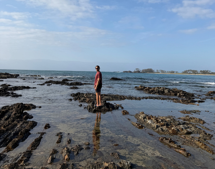 a man walking among rockpools