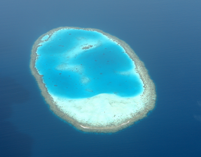 An atoll, a ring of coral reef around a turquoise lagoon