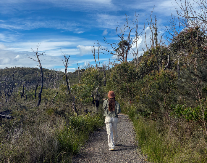 a woman walking on hiking trail at diamond head
